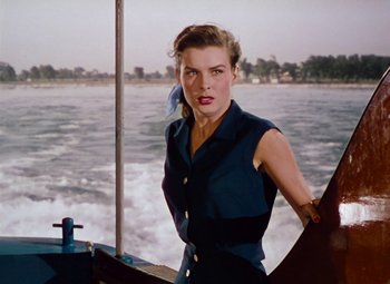 Movie still from “Niagara” (1953), directed by Henry Hathaway – A woman standing on the side of a boat in the water; Medium shot, Low angle