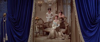 Movie still from “Nicholas and Alexandra” (1971), directed by Franklin J. Schaffner – A group of three women dressed up as queen victoria; Wide shot, Low angle