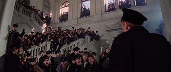 Movie still from “Nicholas and Alexandra” (1971), directed by Franklin J. Schaffner – A group of people sitting in front of a building; Wide shot, High angle