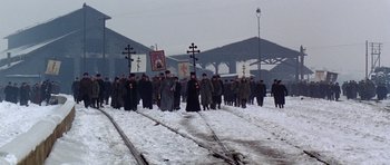 Movie still from “Nicholas and Alexandra” (1971), directed by Franklin J. Schaffner – A group of people walking across a snow - covered train track; Extreme Wide shot, High angle