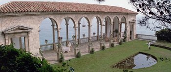 Movie still from “Nicholas and Alexandra” (1971), directed by Franklin J. Schaffner – An outdoor patio with a view of the ocean; Extreme Wide shot, High angle