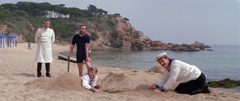 Movie still from “Nicholas and Alexandra” (1971), directed by Franklin J. Schaffner – Three people on the beach playing with a frisbee; Wide shot, High angle