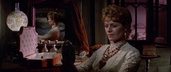 Movie still from “Nicholas and Alexandra” (1971), directed by Franklin J. Schaffner – A woman sitting in front of a mirror looking in the mirror; Close Up shot, Over the shoulder angle