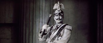 Movie still from “Nicholas and Alexandra” (1971), directed by Franklin J. Schaffner – A man dressed in a military uniform holding a sword; Close Up shot, Low angle