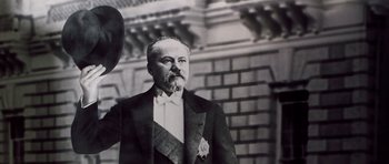 Movie still from “Nicholas and Alexandra” (1971), directed by Franklin J. Schaffner – An old photo of a man wearing a suit and tie; Close Up shot, Low angle
