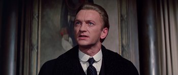 Movie still from “Nicholas and Alexandra” (1971), directed by Franklin J. Schaffner – A person wearing a suit and a tie; Close Up shot, Low angle