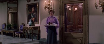 Movie still from “Nicholas and Alexandra” (1971), directed by Franklin J. Schaffner – A woman holding a tray of food in a room; Medium shot, Low angle