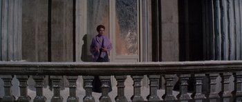 Movie still from “Nicholas and Alexandra” (1971), directed by Franklin J. Schaffner – A woman standing on a porch looking out a window; Wide shot, Low angle