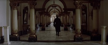 Movie still from “Nicholas and Alexandra” (1971), directed by Franklin J. Schaffner – A person walking in a hallway with pillars; Wide shot, Low angle