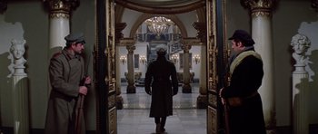 Movie still from “Nicholas and Alexandra” (1971), directed by Franklin J. Schaffner – A man walking through an archway in a building; Wide shot, Low angle