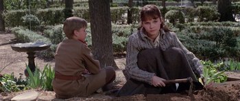 Movie still from “Nicholas and Alexandra” (1971), directed by Franklin J. Schaffner – A woman sitting next to a young boy in a field; Medium shot, Over the shoulder angle