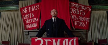 Movie still from “Nicholas and Alexandra” (1971), directed by Franklin J. Schaffner – A man standing in front of a red banner; Medium shot, Low angle