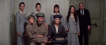 Movie still from “Nicholas and Alexandra” (1971), directed by Franklin J. Schaffner – A group of people sitting in a room together; Medium shot, Low angle