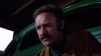 Movie still from “Night Moves” (1975), directed by Arthur Penn – A person with a mustache; Close Up shot, Low angle