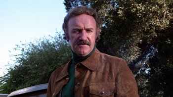 Movie still from “Night Moves” (1975), directed by Arthur Penn – A person wearing a brown jacket; Close Up shot, Low angle