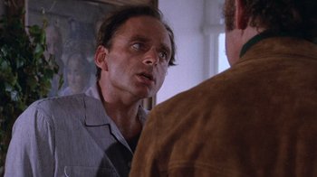 Movie still from “Night Moves” (1975), directed by Arthur Penn – A man is looking at himself in the mirror; Close Up shot, Over the shoulder angle