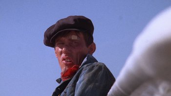 Movie still from “Night Moves” (1975), directed by Arthur Penn – A person wearing a hat; Close Up shot, Low angle