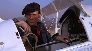 Movie still from “Night Moves” (1975), directed by Arthur Penn – A man sitting in the cockpit of an airplane; Close Up shot, Low angle