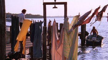 Movie still from “Night Moves” (1975), directed by Arthur Penn – Clothes hanging out to dry on a pier; Wide shot, Low angle