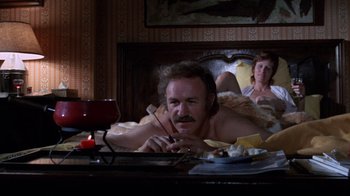 Movie still from “Night Moves” (1975), directed by Arthur Penn – A man and a woman laying in a bed; Medium shot, High angle