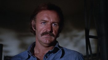 Movie still from “Night Moves” (1975), directed by Arthur Penn – A person with a mustache; Close Up shot, Low angle
