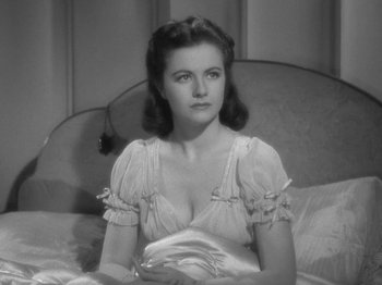 Movie still from “Night Train to Munich” (1940), directed by Carol Reed – A black - and - white photo of a woman sitting on a bed; Close Up shot, High angle