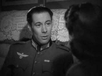 Movie still from “Night Train to Munich” (1940), directed by Carol Reed – A man in a military uniform talking to a woman; Close Up shot, Over the shoulder angle