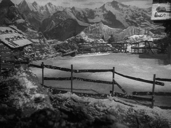 Movie still from “Night Train to Munich” (1940), directed by Carol Reed – A black - and - white photo of a snowy mountain; Extreme Wide shot, High angle