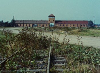 Movie still from “Night and Fog” (1956), directed by Alain Resnais – An old train station in the middle of a field; Extreme Wide shot, High angle