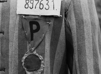 Movie still from “Night and Fog” (1956), directed by Alain Resnais – A black and white photo of a piece of cloth with the letter p written on it; Extreme Close Up shot, Overhead angle