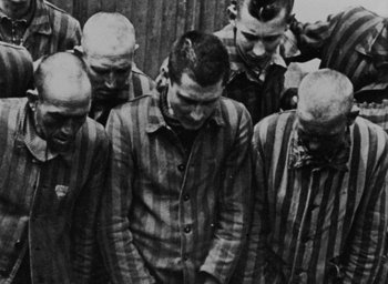 Movie still from “Night and Fog” (1956), directed by Alain Resnais – A group of men standing next to each other; Medium shot, Over the shoulder angle