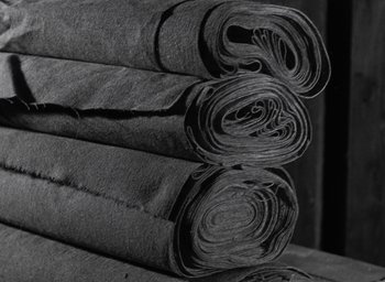 Movie still from “Night and Fog” (1956), directed by Alain Resnais – View of rolls of fabric rolled up together; Extreme Close Up shot, Overhead angle