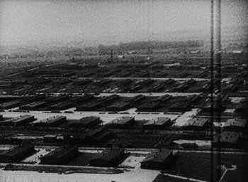 Movie still from “Night and Fog” (1956), directed by Alain Resnais – An aerial view of a large city in the 1 9 5 0 s; Extreme Wide shot, High angle