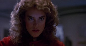 Movie still from “Night of the Comet” (1984), directed by Thom Eberhardt – A person wearing a red shirt; Close Up shot, Low angle
