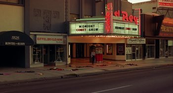 Movie still from “Night of the Comet” (1984), directed by Thom Eberhardt – A movie theater that is lit up at night; Extreme Wide shot, High angle