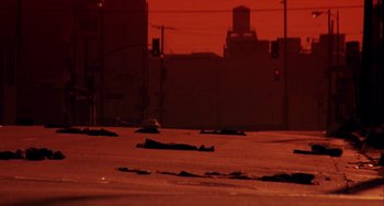 Movie still from “Night of the Comet” (1984), directed by Thom Eberhardt – A street with a red sky in the background; Extreme Wide shot, High angle