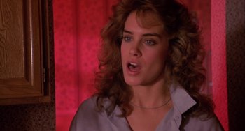 Movie still from “Night of the Comet” (1984), directed by Thom Eberhardt – A person with curly hair; Close Up shot, Low angle