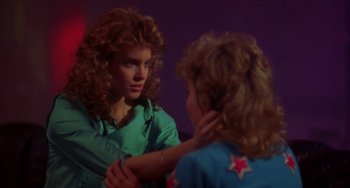 Movie still from “Night of the Comet” (1984), directed by Thom Eberhardt – A woman is looking at her reflection in a mirror; Close Up shot, Over the shoulder angle