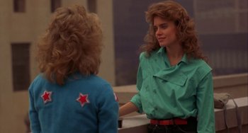 Movie still from “Night of the Comet” (1984), directed by Thom Eberhardt – A woman in a green shirt is talking to another woman; Medium shot, Over the shoulder angle