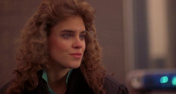 Movie still from “Night of the Comet” (1984), directed by Thom Eberhardt – A person with long hair; Close Up shot, Over the shoulder angle