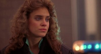 Movie still from “Night of the Comet” (1984), directed by Thom Eberhardt – A person with long hair; Close Up shot, Over the shoulder angle