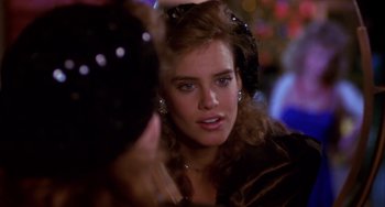 Movie still from “Night of the Comet” (1984), directed by Thom Eberhardt – A woman's face in front of a mirror; Close Up shot, Over the shoulder angle