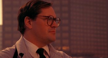 Movie still from “Night of the Comet” (1984), directed by Thom Eberhardt – A person wearing glasses and a tie; Close Up shot, Low angle