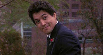 Movie still from “Night of the Comet” (1984), directed by Thom Eberhardt – A person wearing a suit and tie; Close Up shot, Low angle