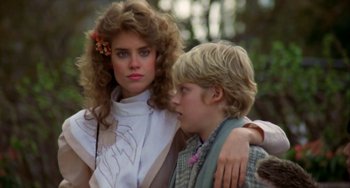Movie still from “Night of the Comet” (1984), directed by Thom Eberhardt – A woman and a young boy standing next to each other; Close Up shot, Over the shoulder angle