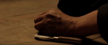 Movie still from “Giant” (2016), directed by Brendan Kelly – A person's hand on a tablet computer on a wooden table; Extreme Close Up shot, High angle
