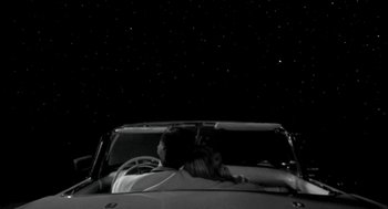 Movie still from “Night of the Creeps” (1986), directed by Fred Dekker – A cat sitting in the driver's seat of a car; Wide shot, High angle