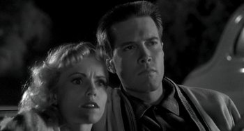 Movie still from “Night of the Creeps” (1986), directed by Fred Dekker – A man and a woman looking at the camera; Close Up shot, Low angle