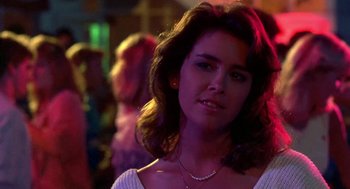 Movie still from “Night of the Creeps” (1986), directed by Fred Dekker – A person wearing a white shirt; Close Up shot, Over the shoulder angle