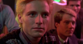 Movie still from “Night of the Creeps” (1986), directed by Fred Dekker – A person wearing a jacket; Close Up shot, Over the shoulder angle